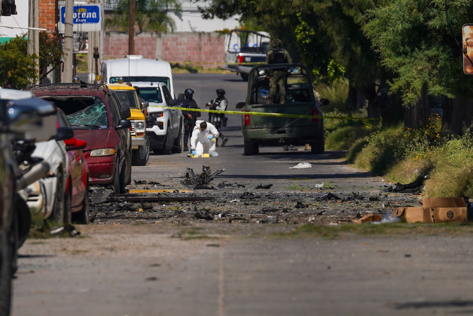 A forensic investigator works the scene where a car bomb exploded near a police station, in Acambaro, Guanajuato state, Mexico, Thursday, Oct. 24, 2024. (AP Photo/Armando Solis)