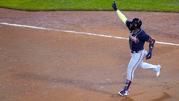 Braves designated hitter Marcell Ozuna raises his arm as he rounds the bases on his solo home run in the seventh inning against the Boston Red Sox, Wednesday Sept. 2, 2020, in Boston. 