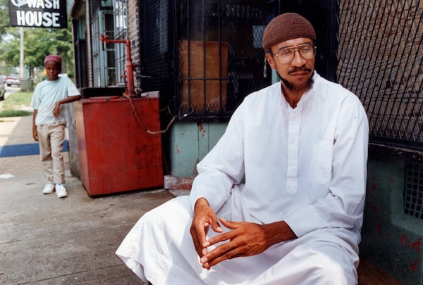 Imam Jamil Abdullah Al-Amin, the former H. Rap Brown, in front of his West End Community grocery store on Oak Street in 1990. (Kathryn Kolb/AJC file photo)