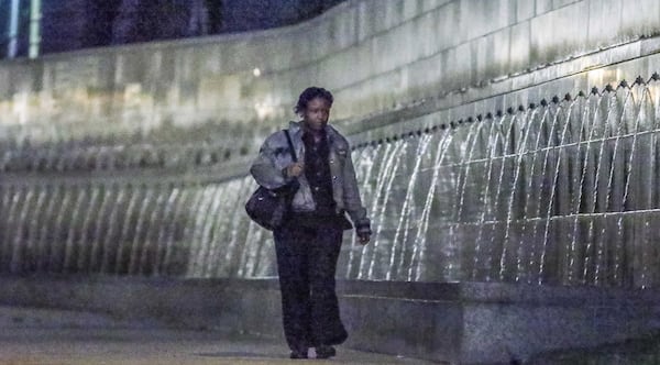 Agnes Manuel needed her jacket Friday morning as she strolled past the fountains at One Atlantic Center. JOHN SPINK / JSPINK@AJC.COM