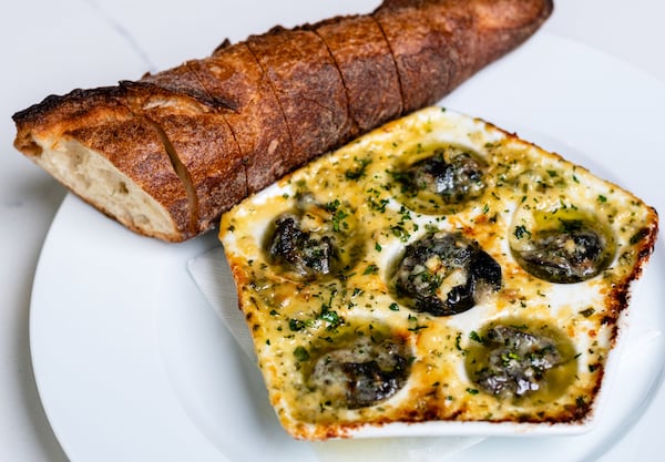 The Brasserie’s escargot appetizer comes with plenty of melted butter and herbs ready to be soaked up with pieces of a baguette. CONTRIBUTED BY HENRI HOLLIS