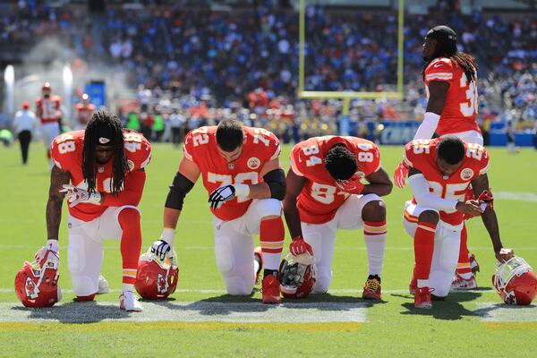 CARSON, CA - SEPTEMBER 24:  Terrance Smith #48, Eric Fisher #72, Demetrius Harris #84, and Cameron Erving #75 of the Kansas City Chiefs is seen taking a knee before the game against the Los Angeles Chargers at the StubHub Center on September 24, 2017 in Carson, California.  (Photo by Sean M. Haffey/Getty Images)