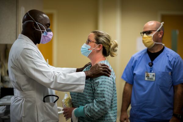 Emanuel Medical Center emergency room physician Dr. Lekan Akinyokunbo, left, speaks with staff member Mary Radford. (Stephen B. Morton for The Atlanta Journal-Constitution)