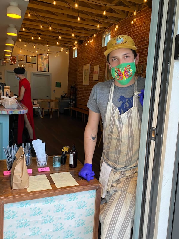 Little Bear chef-owner Jarrett Stieber, seen at the entrance to the restaurant, has one rule: Build dishes layered with flavor. Ligaya Figueras / ligaya.figueras@ajc.com