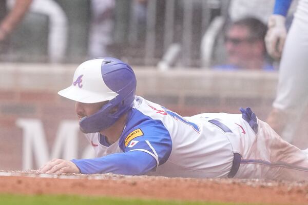 Atlanta Braves' Travis d'Arnaud (16) scores in the fifth inning of a baseball game against the Oakland Athletics, Saturday, June 1, 2024, in Atlanta. (AP Photo/Brynn Anderson)