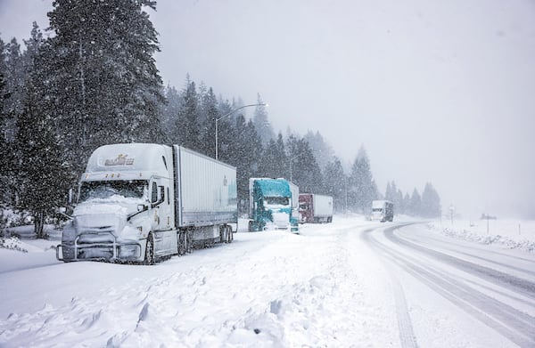 Truckers hole up along the side of I-5 to let the storm pass before the highway is reopened in Weed, Calif., Wednesday, Nov. 20, 2024. (Carlos Avila Gonzalez/San Francisco Chronicle via AP)