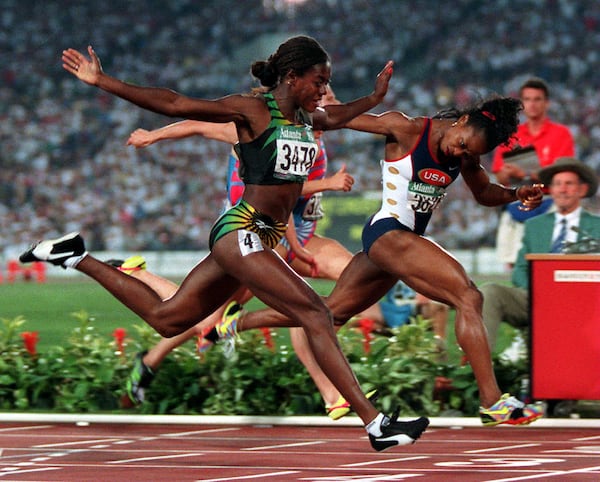 Gail Devers (right), of the U.S., and Merlene Ottey, of Jamaica, cross the finish line in the 1996 Summer Olympics women's 100-meter final Saturday, July 27, 1996, at Olympic Stadium in Atlanta. Devers won gold. (Michael Probst/AP)