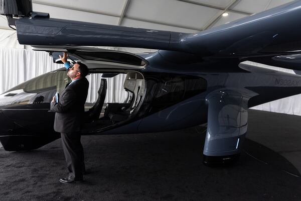 Douglas Hayes, staff manufacturing project manager at Archer, views Archer’s Midnight electric vertical take-off and landing (eVTOL) aircraft at DeKalb-Peachtree Airport in Atlanta on Thursday, July 25, 2024. (Arvin Temkar / AJC)