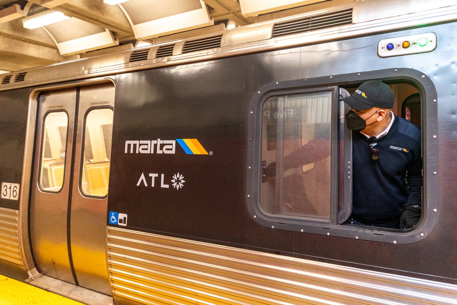 Denny Wyatt checks that his train is safe to depart from Five Points Station on Tuesday.  Some MARTA train and bus trips have been canceled because of staffing problems amid the coronavirus pandemic. (Jenni Girtman for The Atlanta Journal-Constitution)