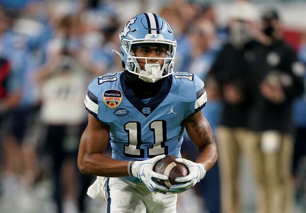 North Carolina's Josh Downs (11) catches his second touchdown pass against Texas A&M, covering 75 yards in the fourth quarter of the Capital One Orange Bowl at Hard Rock Stadium in Miami Gardens, Florida, on Saturday, Jan. 2, 2021. Texas A&M won, 41-27. (Mark Brown/Getty Images/TNS)