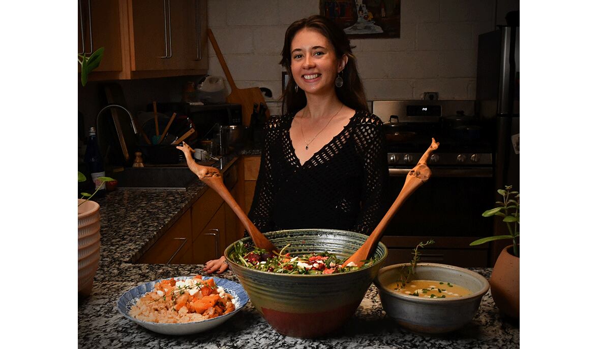 Tatiana Gonzalez is shown in her home kitchen with three winter dishes made from her recipes: (from left) White Bean Chili with Sweet Potatoes, Butternut Squash, Beet, Couscous and Arugula Salad, and Potato Leek Soup. (Styling by Tatiana Gonzalez / Chris Hunt for the AJC)