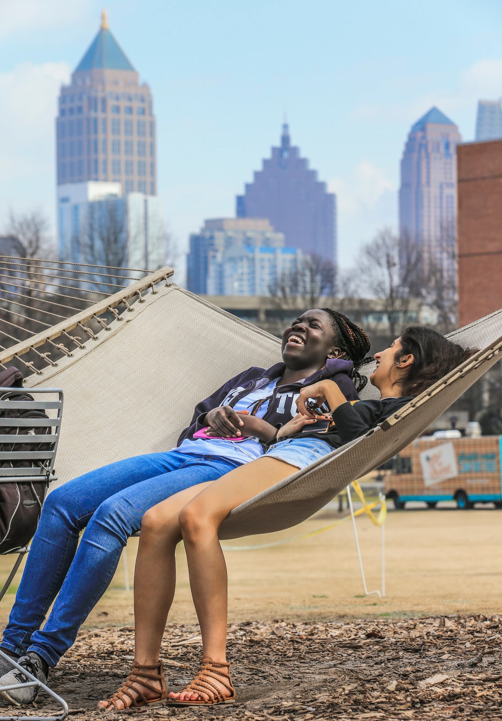 Georgia Tech students Andoza Jamus (left) and Jacki Patel enjoyed the record-setting weather Thursday in a hammock. JOHN SPINK / JSPINK@AJC.COM