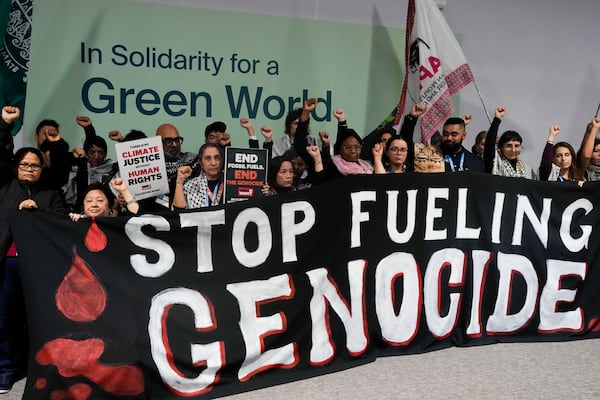 Activists demonstrate for climate justice and a ceasefire in the Israel-Hamas at the COP29 U.N. Climate Summit, Monday, Nov. 11, 2024, in Baku, Azerbaijan. (AP Photo/Rafiq Maqbool)