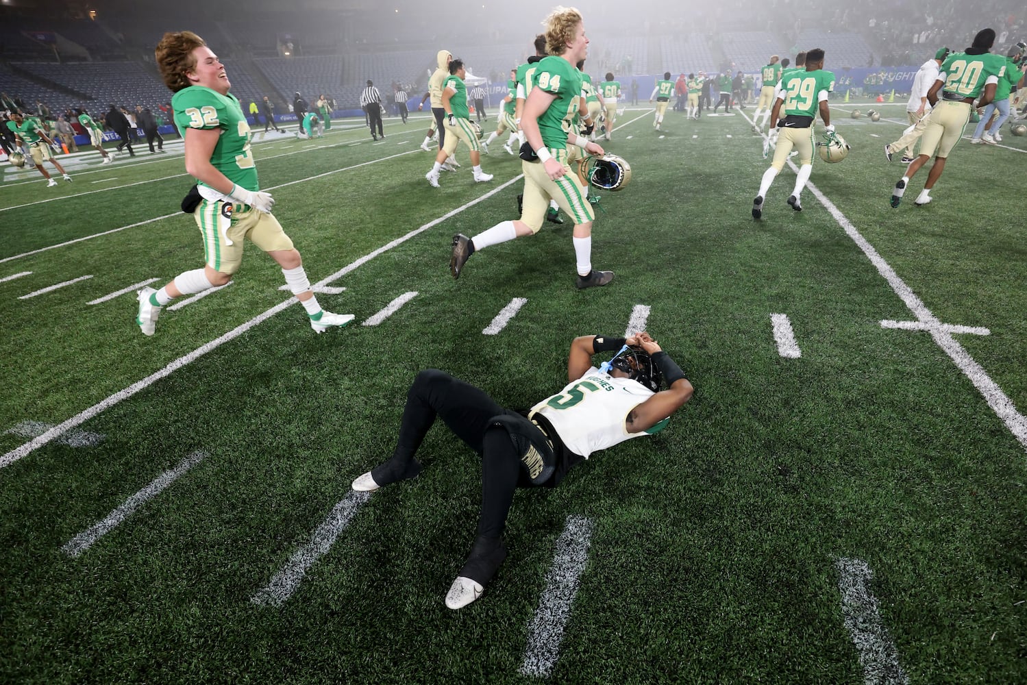 Langston Huges wide receiver Armani Tookes (5) reacts after their kicker missed the field goal as Buford players celebrate their 21-20 victory as time expires during the Class 6A state title football game at Georgia State Center Parc Stadium Friday, December 10, 2021, Atlanta. JASON GETZ FOR THE ATLANTA JOURNAL-CONSTITUTION