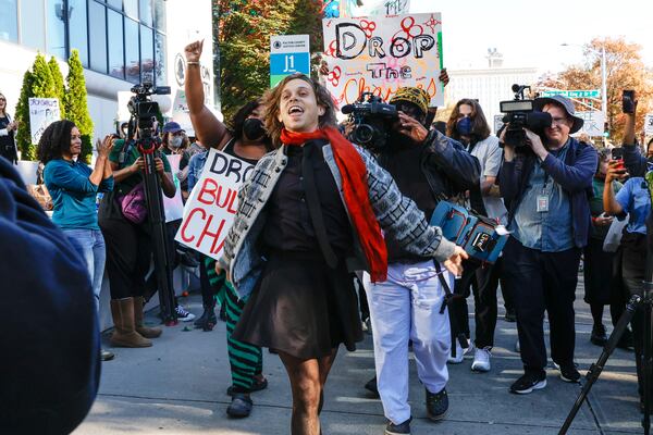 Jamie Marsicano dances into Fulton County Courthouse to be arraigned on Monday, Nov. 6, 2023. Marsicano is one of 61 defendants named in Georgia Attorney General Chris Carr’s RICO indictment against Atlanta Public Safety Center protestors.  (Natrice Miller/ Natrice.miller@ajc.com)