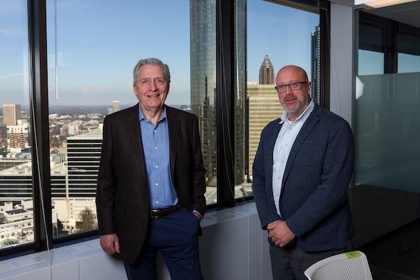 Ron Stang (left) and Todd Dolson stand in their office space at 100 Peachtree St. on  Jan. 13 in Atlanta. (Jason Getz/AJC)