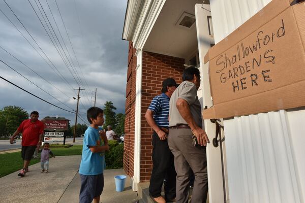 Residents of Shallowford Gardens Apartments arrive for a meeting on Wednesday, June 14, 2017, to hear about the DeKalb County School District’s purchase of their apartment complex. A new elementary school is to be bult there to alleviate overcrowding in the Cross Keys cluster of schools. Dozens of families in the 104-unit complex have until the end of August to find new housing. HYOSUB SHIN / HSHIN@AJC.COM