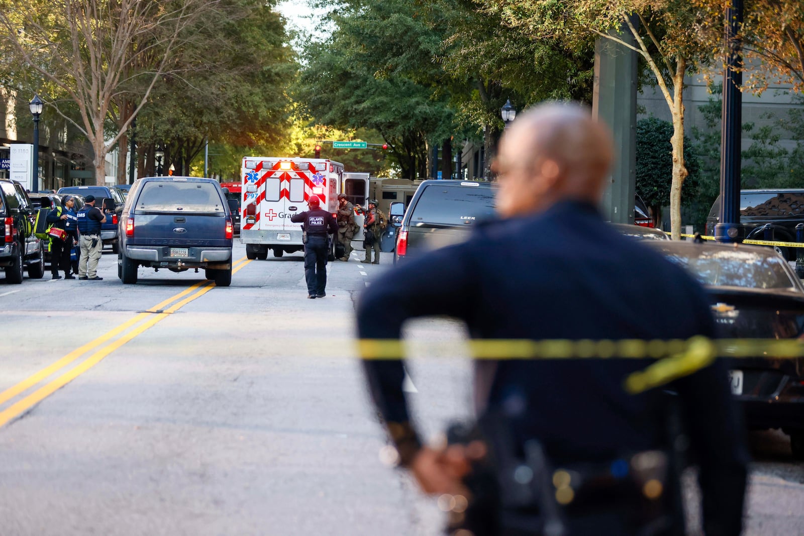 Atlanta Police officers and representatives from other agencies cleared the scene on 14th Street outside the Four Seasons Hotel in the Midtown neighborhood of Atlanta, Tuesday, Oct. 29, 2024, after a suspect was taken into custody following gunshots reported. (Miguel Martinez/Atlanta Journal-Constitution via AP)