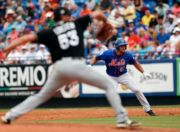 New York Mets' Tim Tebow (97) takes a lead off first base as Miami Marlins starting pitcher Kyle Lobstein (53) throws to the plate in the fifth inning of a spring training baseball game Monday, March 13, 2017, in Port St. Lucie, Fla. Tebow reached first with his first base hit of spring training.