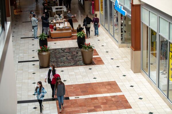 02/17/2021 —Kennesaw, Georgia — People wear face masks as they walk through the Town Center at Cobb Shopping Mall in Kennesaw ,Wednesday, February 17, 2021. (Alyssa Pointer / Alyssa.Pointer@ajc.com)