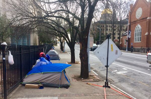 Perhaps a dozen homeless people camp out nightly along MLK Jr. Drive in downtown Atlanta. (Photo by Bill Torpy / AJC)