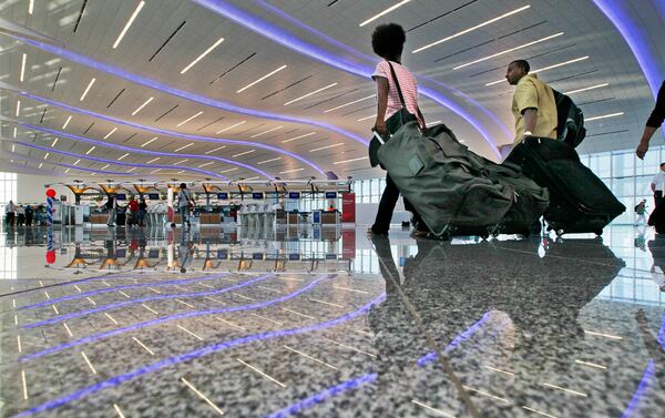 May 16, 2012 Atlanta: People arrived early in the morning to check in Wednesday, May 16,2012 before the first flight took off from the new international terminal at Hartsfield-Jackson International Airport at 1:25 p.m. The new terminal's price tag exceeded $1.4 billion. Airport work is funded through a combination of passenger facility charges, airline lease and landing fee payments, revenue from airport operations like concessions and parking, and federal grants. The revenue streams are often used to back bonds or other financing. critics of the new terminal complain that it cost twice original projections and has fewer gates than the original plan. They also have complained about the political process behind the scenes. Travelers in Atlanta will have to get used to accessing the new terminal by arriving on the I-75 side of what was a familiar trip to the airport by way of I-85. JOHN SPINK /