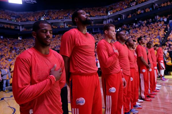 Los Angeles Clippers players listen to the national anthem wearing their warmup jerseys inside out to protest alleged racial remarks by team owner Donald Sterling before Game 4 of an opening-round NBA basketball playoff series against the Golden State Warriors on Sunday, April 27, 2014, in Oakland, Calif. (AP Photo/Marcio Jose Sanchez) The Clippers and their generic shirts. (Marcio Jose Sanchez/AP)