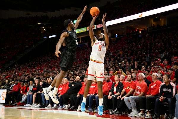 Maryland guard Selton Miguel (9) shoots against Michigan State guard Tre Holloman (5) during the second half of an NCAA college basketball game, Wednesday, Feb. 26, 2025, in College Park, Md. (AP Photo/Nick Wass)