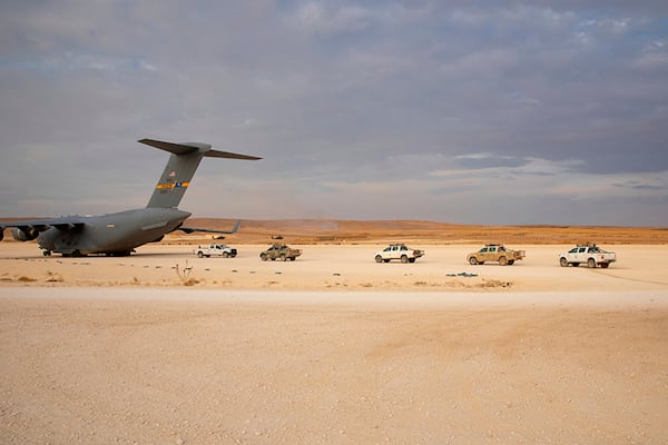 In this Oct. 25 photo, released by the U.S. Army Reserve,  vehicles lined up to be loaded onto a cargo plane as part of the deliberate withdrawal of coalition forces from northern Syria at the Kobani Landing Zone (KLZ).