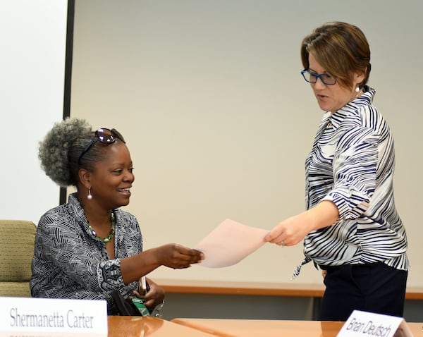 DeKalb County Board of Ethics member Shermanetta Carter (left) and Ethics Officer Stacey Kalberman talk before the DeKalb Board of Ethics meeting on August 1, 2017. 