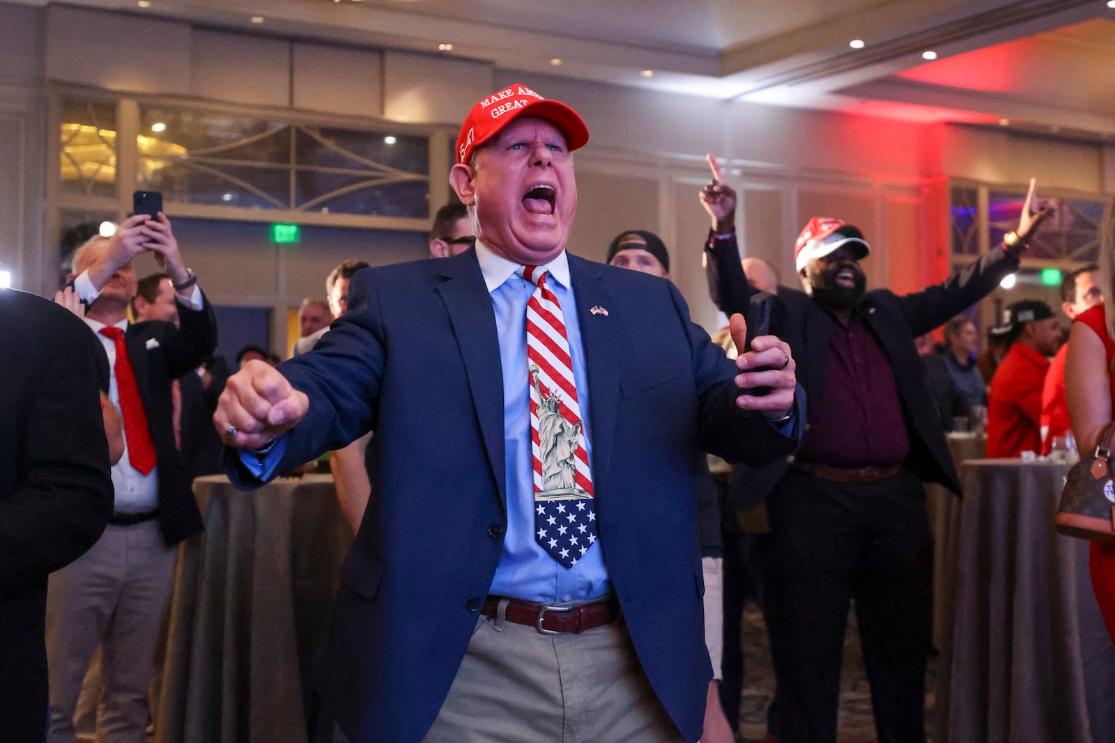 Trump supporter Eddie Cannon, of Norcross, reacts as Trump is predicted to take North Carolina during the Georgia GOP election night watch party at the Grand Hyatt Hotel Buckhead, Tuesday, Nov. 5, 2024, in Atlanta. (Jason Getz / AJC)
