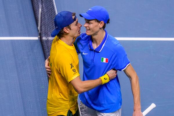 Italy's Jannik Sinner embraces after winning against Australia's Alex de Minaur during the Davis Cup semifinal at the Martin Carpena Sports Hall in Malaga, southern Spain, on Saturday, Nov. 23, 2024. (AP Photo/Manu Fernandez)