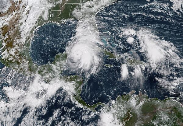 A satellite image provided by the National Oceanic and Atmospheric Administration shows Tropical Storm Michael churning toward the Florida Panhandle in the Gulf of Mexico on Oct. 8, 2018. Michael, which turned into a hurricane, raced toward Florida on Tuesday, threatening to bring the ferocious rains and winds of a powerful tropical cyclone to the coast and hundreds of miles inland. (National Oceanic and Atmospheric Administration)