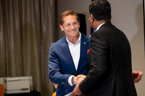 U.S. Rep. Rich McCormick, left, shakes hands with the Consul General of India to Atlanta, Shri Ramesh Babu Lakshmanan, during a trade event hosted by the Georgia Indo-American Chamber of Commerce in Atlanta on Wednesday, March 27, 2024.   (Ben Gray / Ben@BenGray.com)