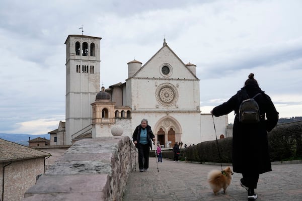 Visitors walk on the parvis of St. Francis Basilica in Assisi, Italy, Saturday, March 1, 2025. (AP Photo/Gregorio Borgia)