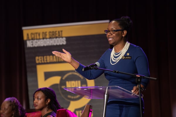 Leah LaRue, director of the NPU system for the city department of planning, speaks at a panel discussion about the neighborhood advocacy groups at Friendship Baptist Church on March 21. (Riley Bunch / AJC)