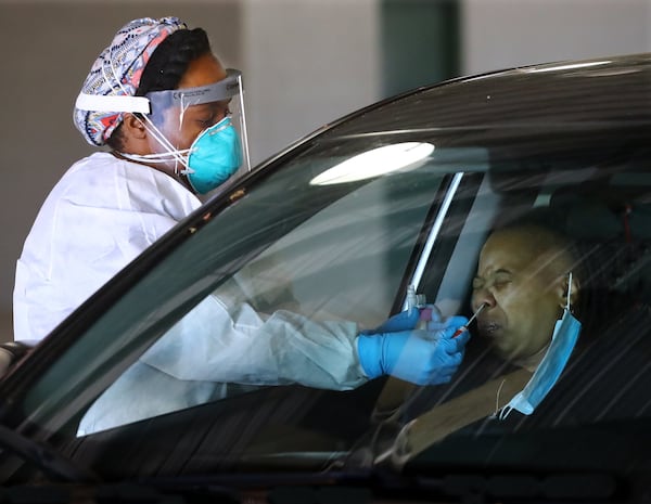 GNR Health Department LPN LaToya Parterat takes a nasal swab at a large scale drive-through COVID-19 testing site at the Georgia International Horse Park recently on Thursday, April 16, 2020, in Conyers. Health workers are going to begin testing Fulton and DeKalb residents for coronavirus antibodies, to learn how widely the virus has spread. CURTIS COMPTON CCOMPTON@AJC.COM