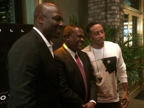 Ludacris poses with actorAdewale Akinnuoye-Agbaje, left, and Dr. Bennet Omalu at the "Concussion" red carpet event.