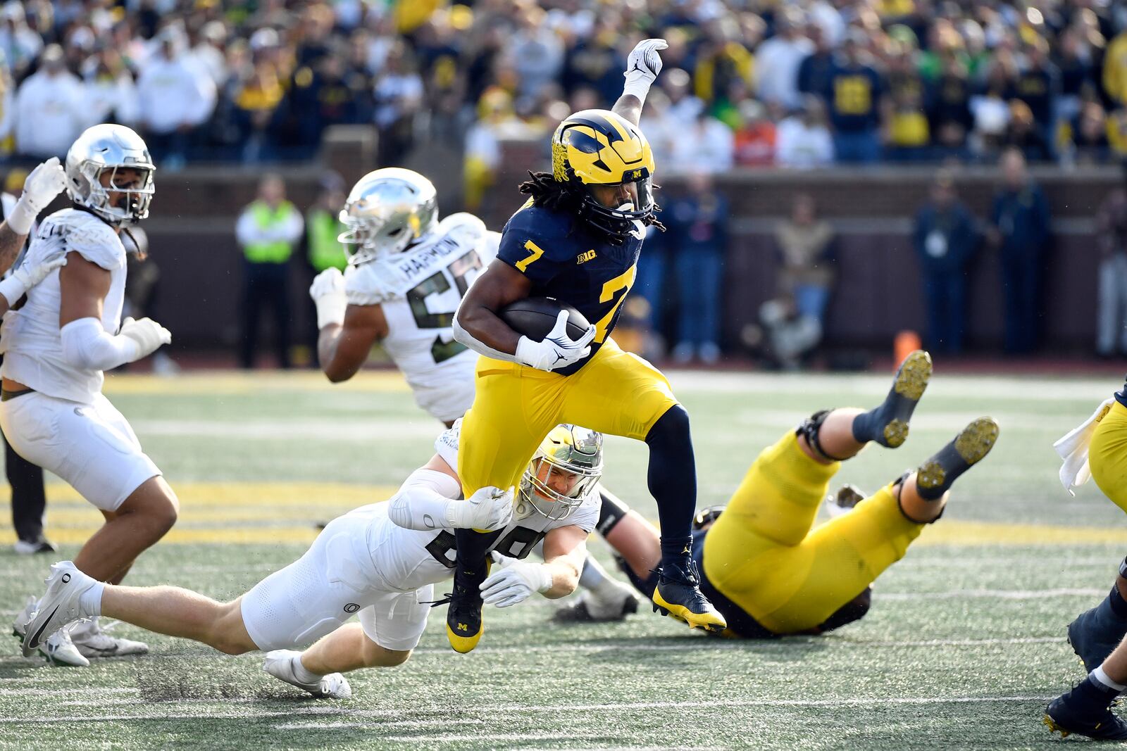 Michigan running back Donovan Edwards (7) evades a tackle by Oregon linebacker Bryce Boettcher (28) in the first half of an NCAA college football game, Saturday, Nov. 2, 2024, in Ann Arbor, Mich. (AP Photo/Jose Juarez)