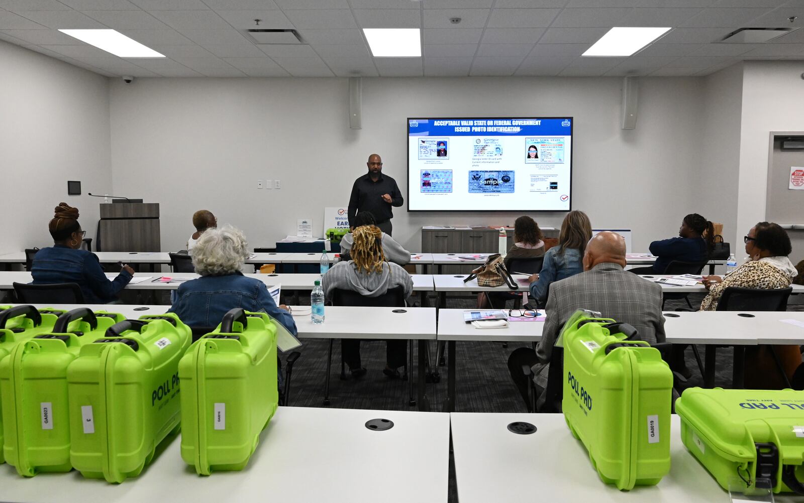 Poll workers participate in training earlier this month for early voting at the Fulton County Elections Hub and Operations Center in Fairburn. (Hyosub Shin / AJC)