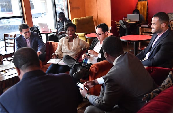 Janelle Jones talks as other members of Millennial Round Table of GA (clockwise from left) Tony Gonzalez, Christopher Perlera, Leonte Benton, Greg Clay and Otis Threatt listen at Urban Grind coffeehouse in Atlanta on Tuesday, December 20, 2016. HYOSUB SHIN / HSHIN@AJC.COM