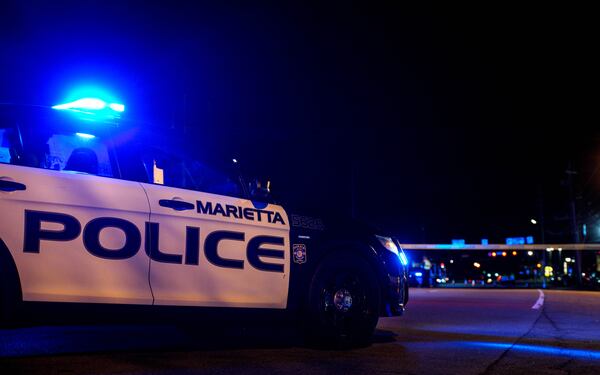 Marietta police vehicles block the scene on Franklin Gateway after a pedestrian was killed Friday.