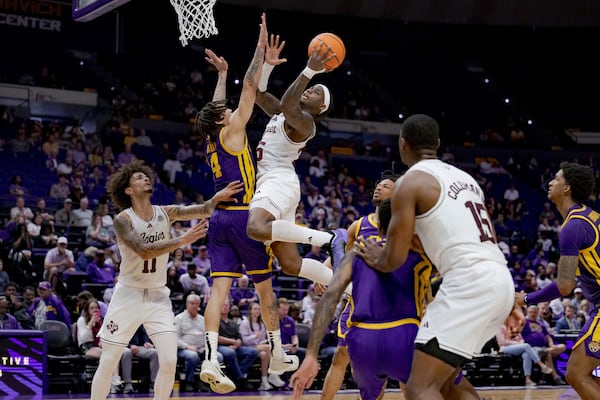 Texas A&M guard Manny Obaseki (35) shoots against LSU guard Dji Bailey (4) during the second half of an NCAA college basketball game in Baton Rouge, La., Saturday, March 8, 2025. (AP Photo/Matthew Hinton)