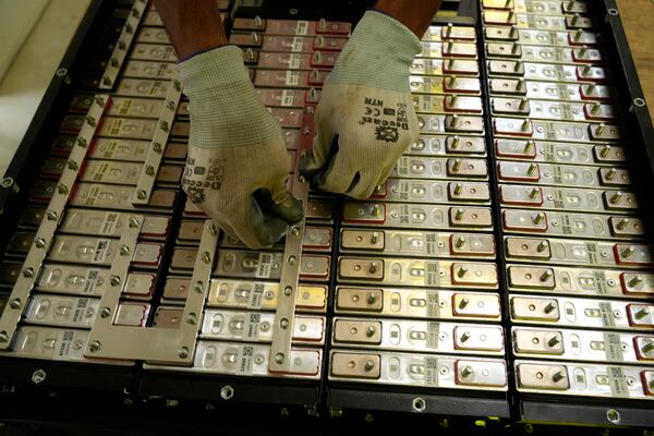 A battery production engineer at Nunam assembles a refurbished battery pack, made from used electric vehicle batteries, at their facility in Bengaluru, India, Tuesday, Oct. 8, 2024. (AP Photo/Aijaz Rahi)