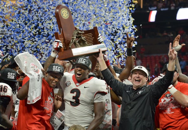 December 2, 2017 Atlanta: Georgia Bulldogs linebacker Roquan Smith (3), head coach Kirby Smart, and Georgia teammates celebrate after defeating the Auburn Tigers 28-7 during the Southeastern Conference championship NCAA college football game at Mercedes-Benz Stadium, December 2, 2017, in Atlanta.  Hyosub Shin / hshin@ajc.com