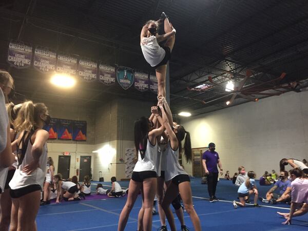 Cheerleaders with Rockstar Cheer Atlanta in Woodstock practice on Feb. 3 for Cheersport Nationals 2021, a major cheerleading competition being held at the Georgia World Congress Center on Valentine's Day weekend. (Johnny Edwards / Johnny.Edwards@ajc.com)