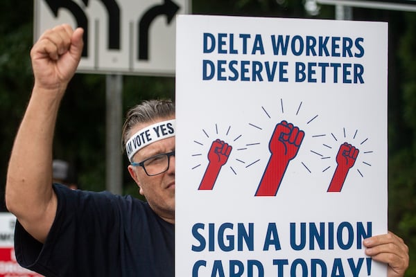 Felipe Martinez, ramp worker at Delta Airline interacts with passing traffic at a Delta airline labor rally near Hartsfield-Jackson International Airport in Atlanta on Wednesday, July 17, 2024.  (Ziyu Julian Zhu / AJC)