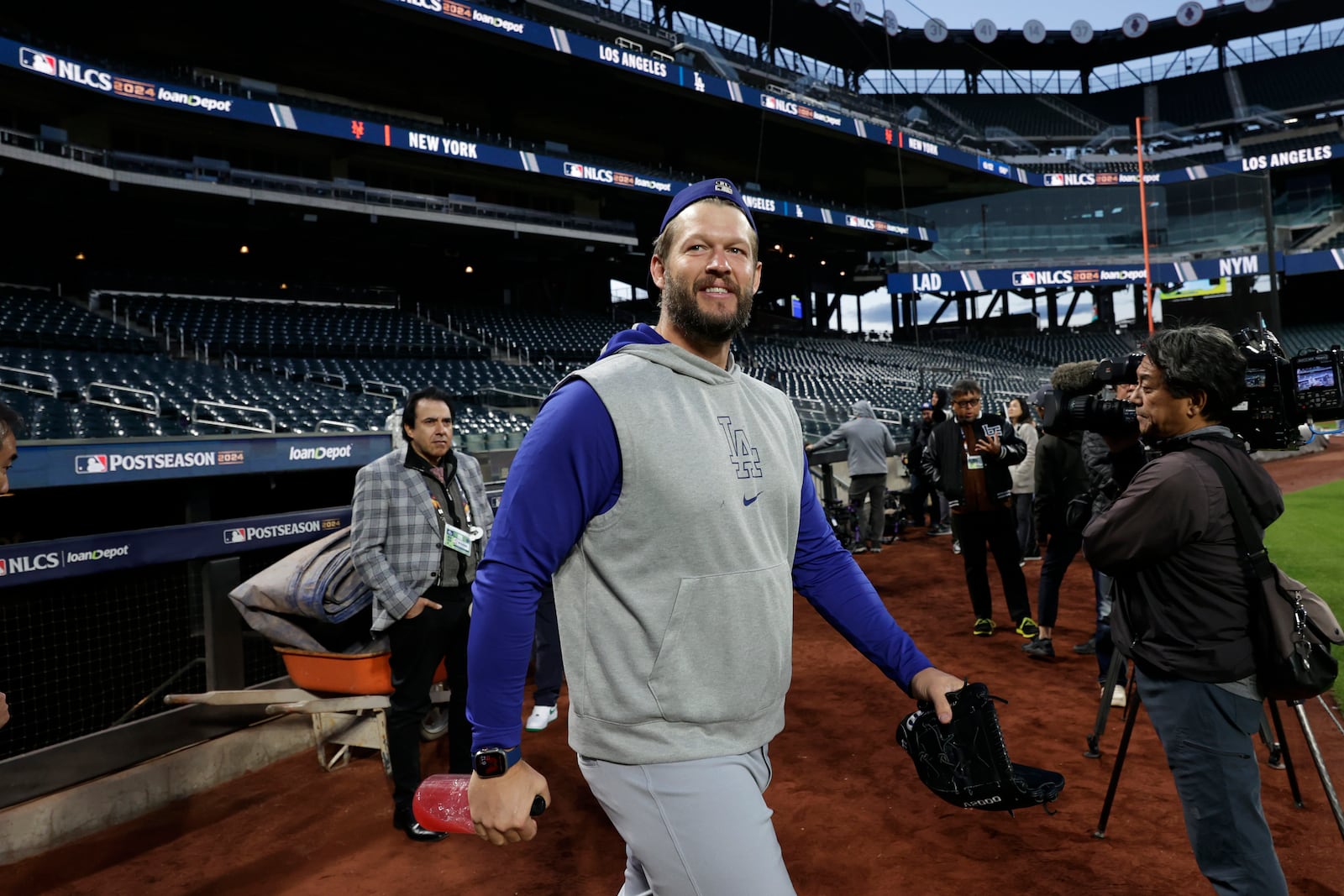 Los Angeles Dodgers pitcher Clayton Kershaw walks onto the field for a team workout Tuesday, Oct. 15, 2024, in New York ahead of Game 3 of the baseball NL Championship Series against the New York Mets. (AP Photo/Adam Hunger)