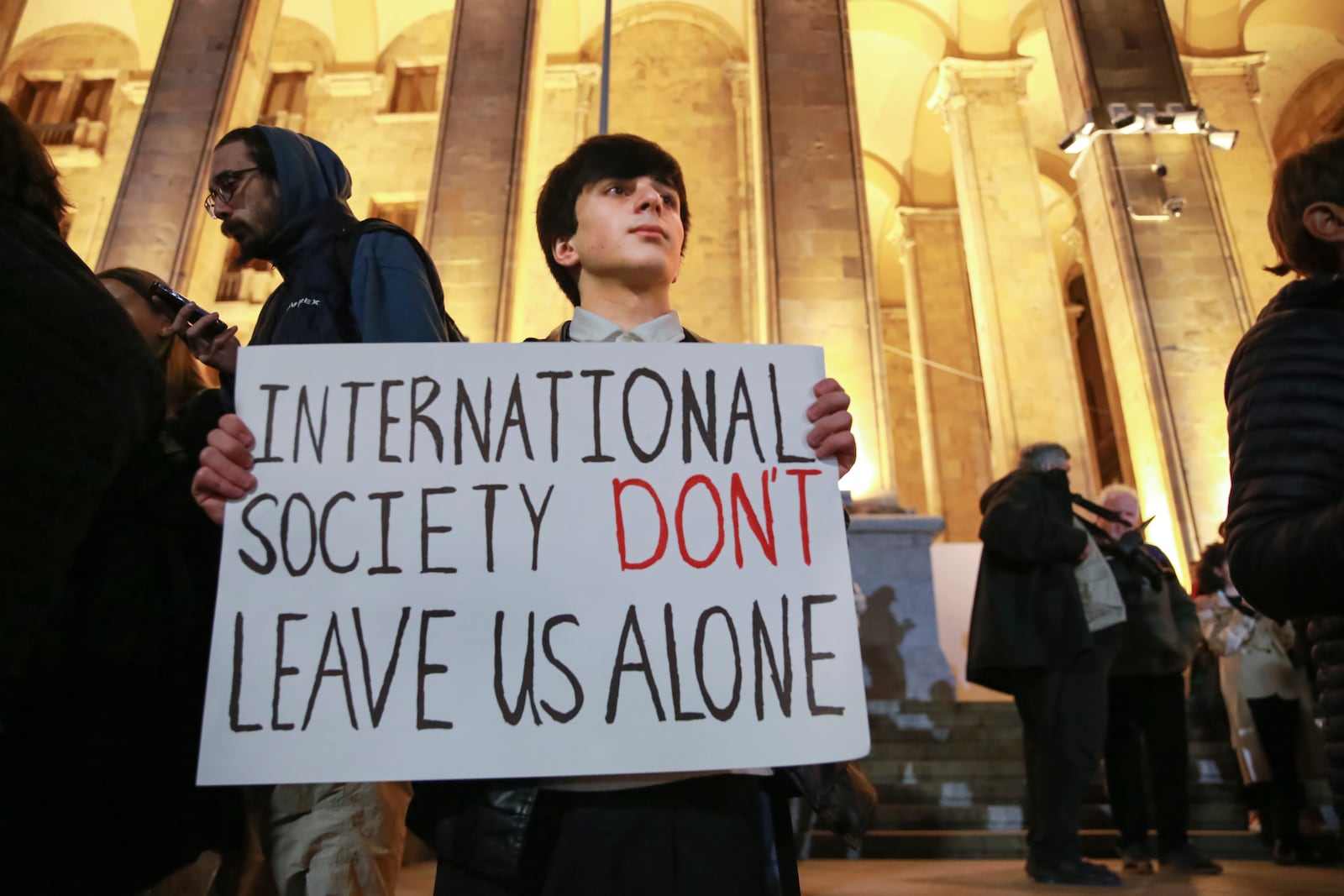 A young demonstrator holds a poster during an opposition protest against the results of the parliamentary election in Tbilisi, Georgia, Monday, Oct. 28, 2024. (AP Photo/Zurab Tsertsvadze)