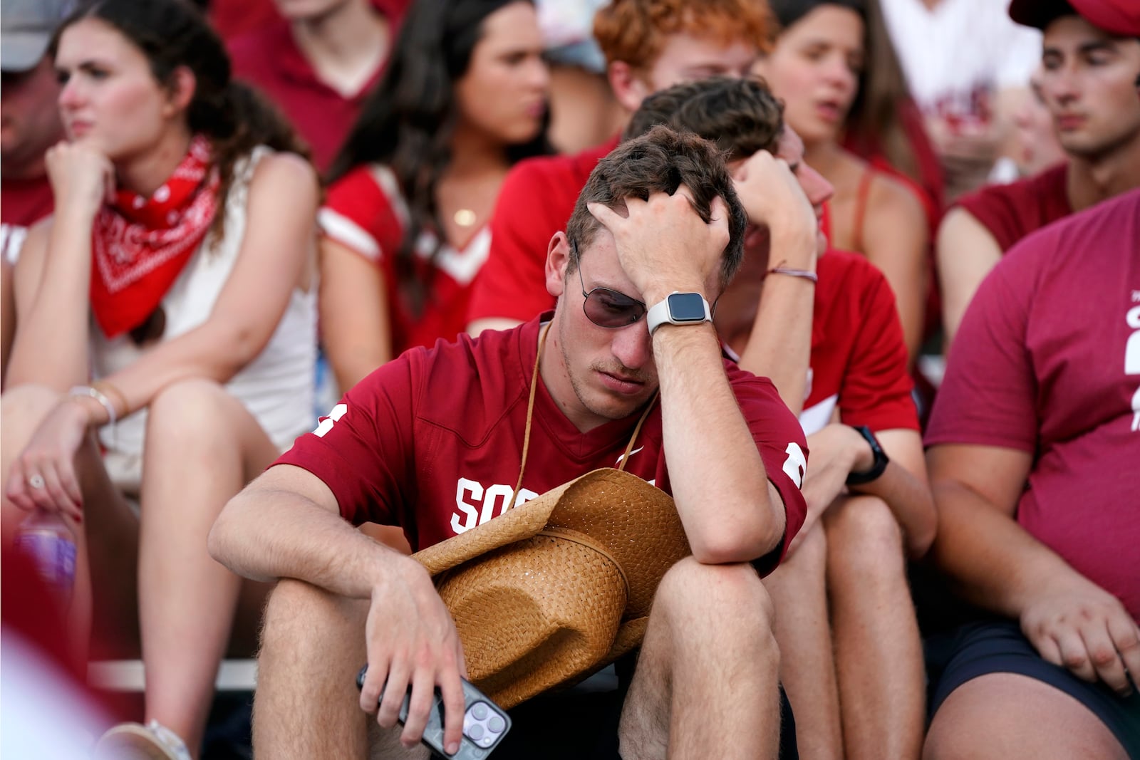 Oklahoma fans react to play in the second half of an NCAA college football game against Texas in Dallas, Saturday, Oct. 12, 2024. (AP Photo/Jeffrey McWhorter)